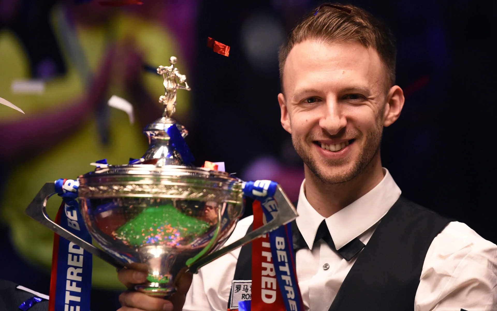 Jessie May ambassador, Judd Trump, holding trophy after winning World Championship Finals in 2019