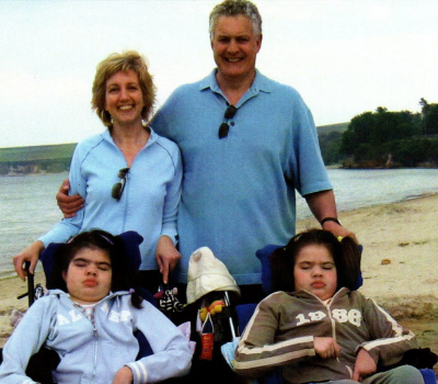 Family of four standing on a beach